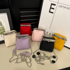 Detailed view of mini lipstick chain bags in multiple colors with lychee texture leather