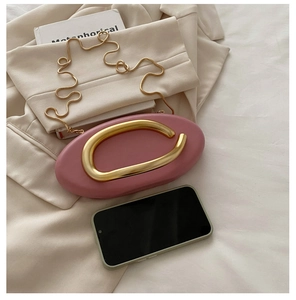 Pink oval evening bag size comparison with smartphone and gold metal handle