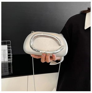 Detail of silver pearlescent acrylic bag with metal ring handle and chain strap