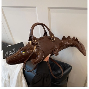 Macro detail of glossy crocodile-shaped handbag with realistic scale texture and gold hardware