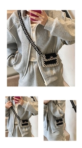 Detail of hand-woven mini crossbody bag with pearl chain and flower clasp on model