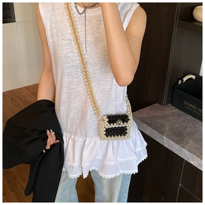 Chic mini hand-woven pearl crossbody bag with black and white beads and golden flower buckle