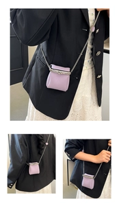 Detail of purple lychee pattern leather mini lipstick bag with silver kiss-lock and chain