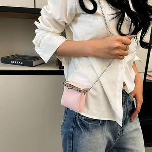 Close-up of pink mini crossbody bag with litchi texture and silver chain strap