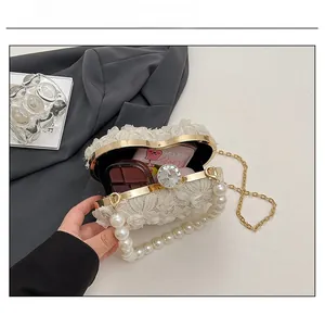 Interior view showing capacity of heart-shaped lace evening bag with pearls