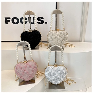 Collection of heart-shaped lace evening bags with pearl handles and gold chains