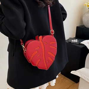 Unique red leaf-shaped crossbody bag with glitter veins on a black blazer outfit