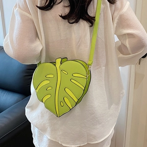 Creative lime green leaf shaped crossbody bag with artistic cutout design for women