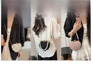 Detailed views of lace heart evening bag showing pearl handle and metal chain straps