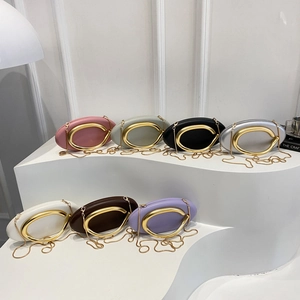 Oval clutch bag with metal handle and gold chain strap in multiple elegant colors