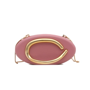 Elegant pink oval evening clutch bag with gold C-logo metal handle and chain strap