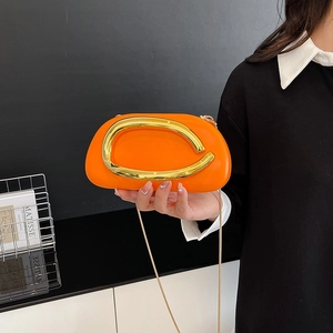 Modern orange acrylic box bag with gold metal handle and chain strap for evening parties