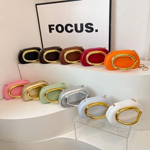 Minimalist evening clutch bags with oversized C-shaped metal rings and elegant chain straps