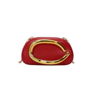 Elegant red leather evening bag with large gold C-ring buckle and chain shoulder strap