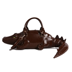 Creative dark brown crocodile-shaped handbag with textured patent leather and gold hardware