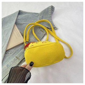 Detailed texture of yellow corduroy bucket bag featuring red heart embroidery accents