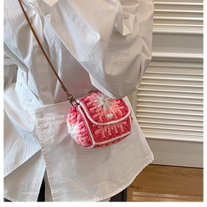 Detail of pink floral crochet mini bag with pearl button and slim brown strap