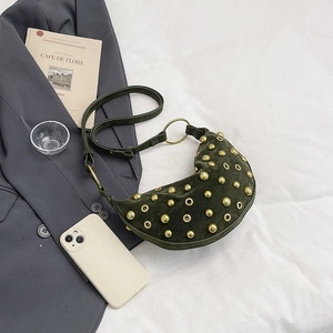 Dark green suede crescent crossbody bag with punk style gold studs and eyelet details