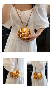 Detail of handmade knit crossbody bag with floral pattern and pearl button closure