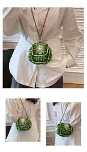 Detail of green handmade crochet mini bag with white floral 3D pattern and pearl clasp