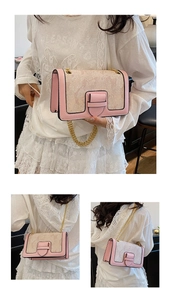 Detailed view of pink and beige jacquard shoulder bag with elegant gold chain strap