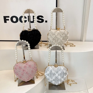 Elegant heart-shaped lace evening bags with pearl handles and chain straps in four colors