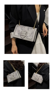 Detail of grey crossbody bag featuring textured fabric, flap closure, and gold chain strap