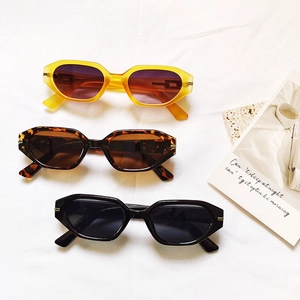 Three pairs of trendy geometric sunglasses in yellow, tortoiseshell, and black colors