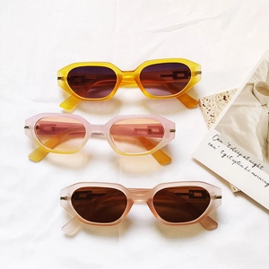 Chic cat-eye sunglasses with thick matte frames in yellow and pink, trendy eyewear collection