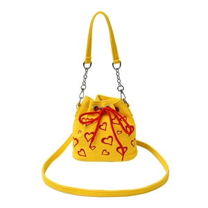Yellow corduroy bucket bag with red heart embroidery and drawstring chain strap