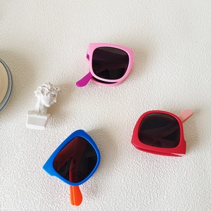 Foldable kids sunglasses in pink red and blue with durable frames and UV protection