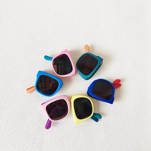Detailed top view of colorful foldable kids sunglasses arranged in a circular pattern