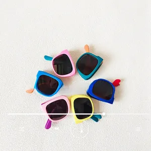 Detailed flat lay of foldable children's sunglasses in six vibrant matte colors