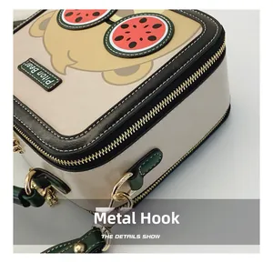 Detail of metal zipper and hardware hook on the cute cartoon bear square bag