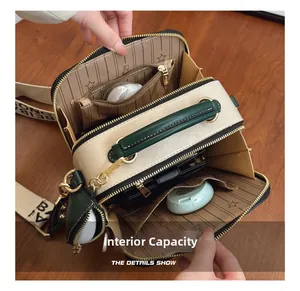 Internal view of a cute cartoon crossbody bag showing spacious double zip compartments