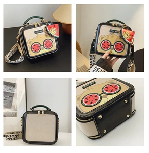 Detail view of cartoon bear crossbody bag with watermelon glasses and wide woven strap