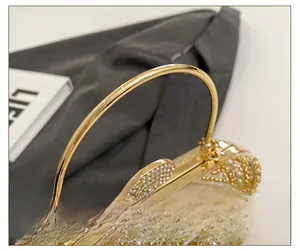 Detail of luxury evening bag with golden beads, pearls and sparkling diamond clasp