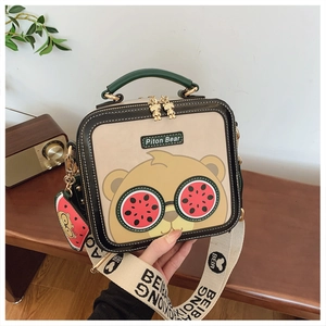 Detail of cartoon bear square bag featuring watermelon glasses and logo strap