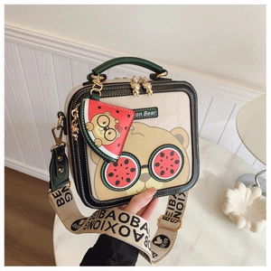 Macro shot of cartoon bear bag with watermelon accessory and wide strap detail