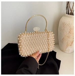 Detail of evening clutch bag with white pearl inlay and gold metal handle