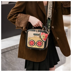 Detail of cartoon bear crossbody bag with watermelon sunglasses and a small charm