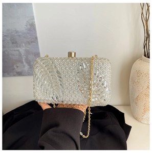 Silver sequin evening clutch with leaf pattern texture and gold chain strap