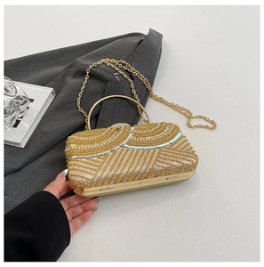 Detailed view of luxury gold sequined evening bag with metallic handle and bead patterns