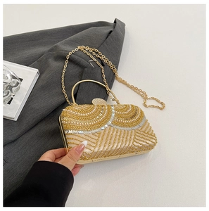 Detail of champagne gold evening bag with pearls, sequins and fine beadwork patterns