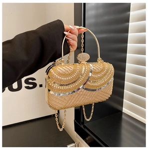 Detail of champagne gold evening bag featuring pearl sequins and crystal ring handle