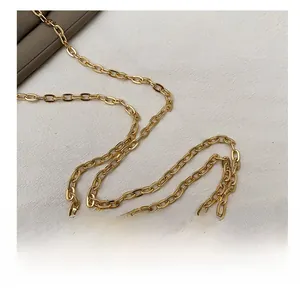 Detailed close-up of polished gold metal chain strap for stylish evening heart bag