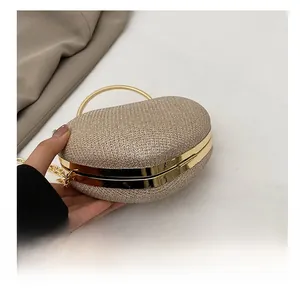 Detail of the champagne gold glitter heart clutch with durable metal frame and base