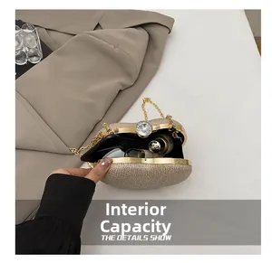 Detailed interior view of a sparkling champagne gold evening clutch with chain strap