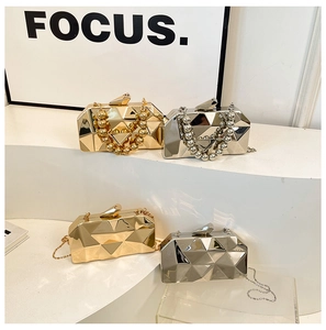 Macro detail of metallic evening bags with geometric faceted design in gold and silver