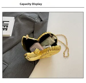 Detail view of conch clutch bag opening to show internal capacity for phone and cosmetics